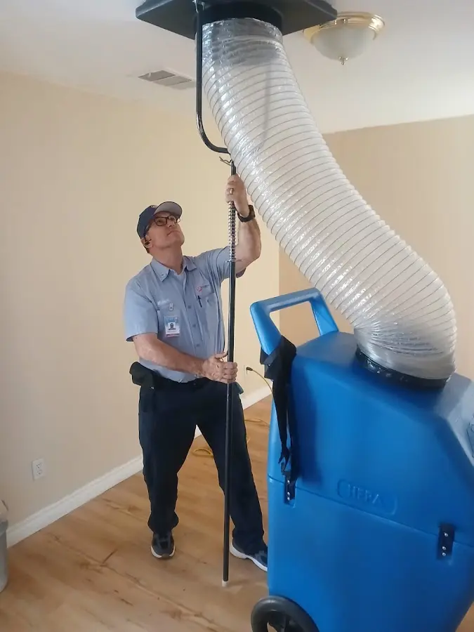 Furnace Tune-Up technician using HEPA equipment in Altamonte Springs