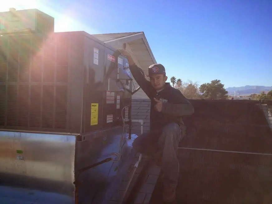 HVAC technician performing AC Tune-Up on a rooftop unit in Altamonte Springs